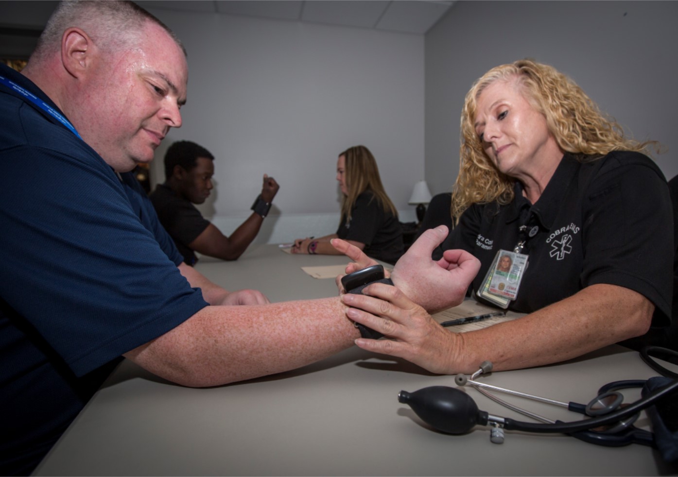 Paramedic Kendra Cobb checks the vitals of responder at the COBRA Training Facility. Responder-Students’ vitals are checked both before and after they enter ‘hot’ bays at the facility.